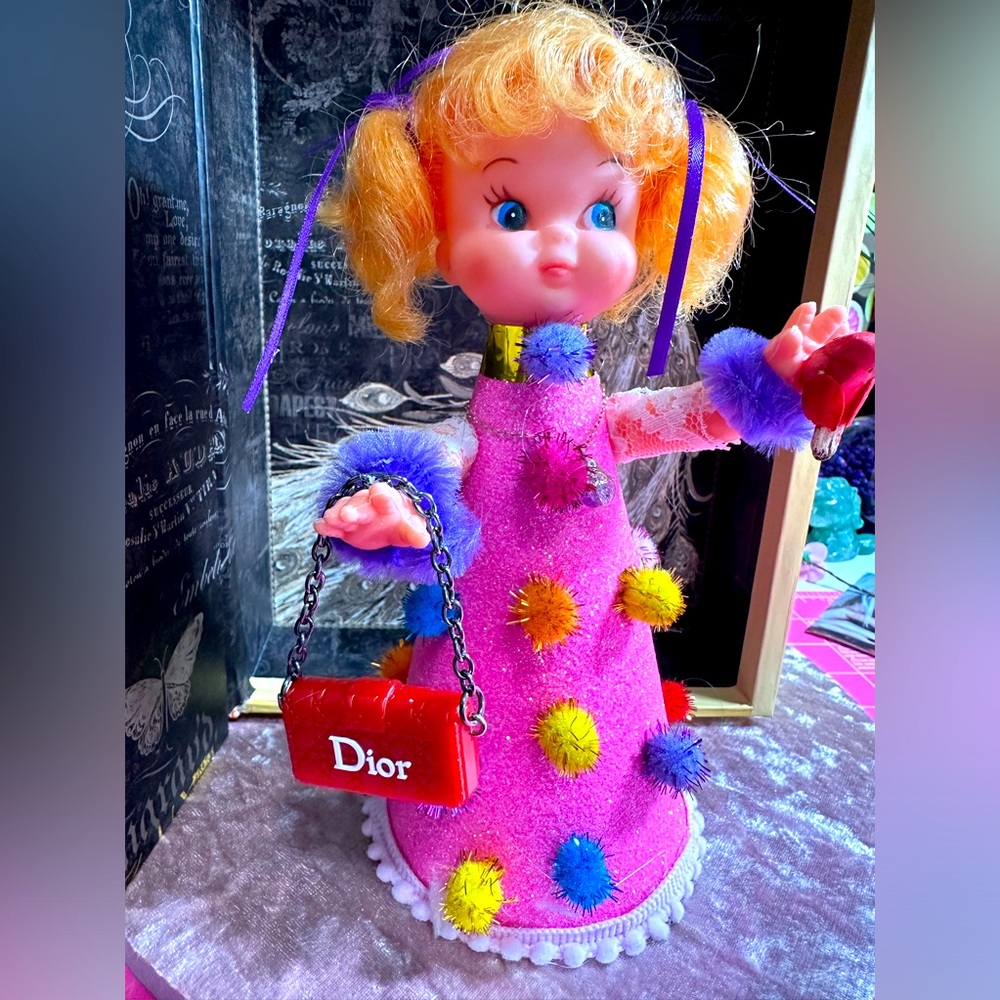 Handcrafted and up-cycled vintage baby doll. She’s carrying a Dior purse! 👛
